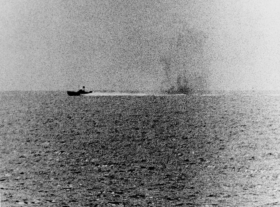 A photograph taken from the USS Maddox on August 2, 1964, showing a North Vietnamese torpedo boat racing by with what appears to be smoke from the Maddox’s shells in its wake. Courtesy of the U.S. Navy Naval History and Heritage Command.