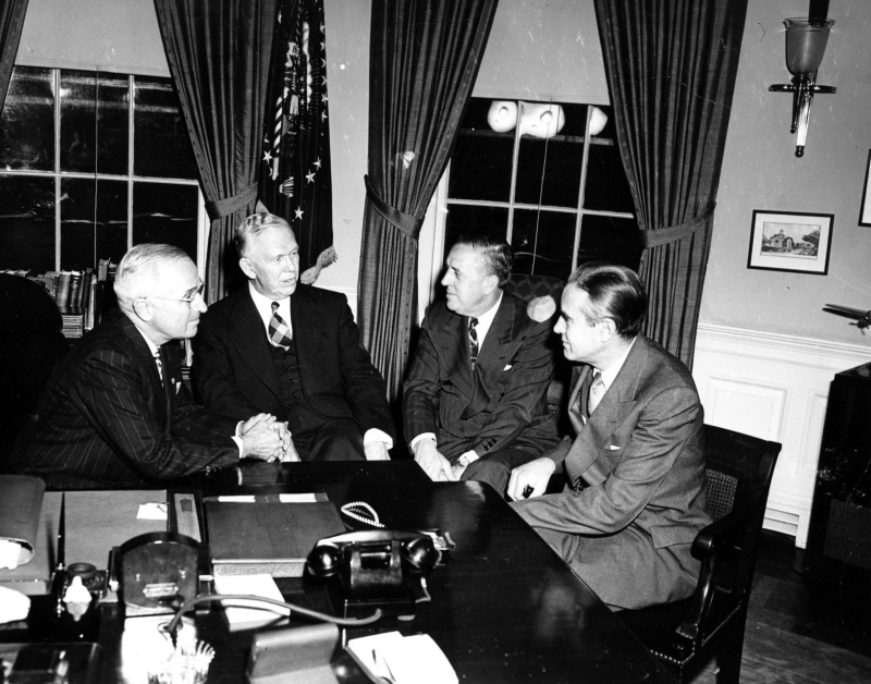 Courtesy of the National Archives photo no. 73-2876, Harry S. Truman Discussing Marshall Plan with George C. Marshall, Paul Hoffman, and Averell Harriman, 1948